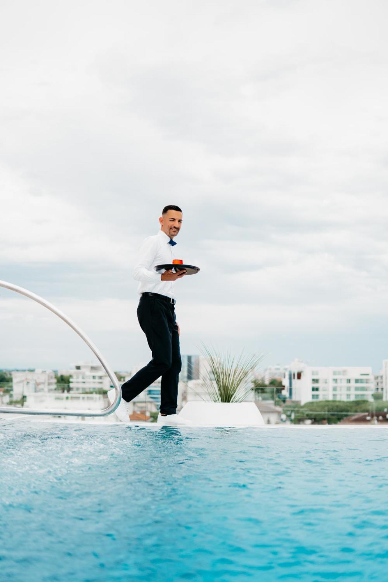 J44 Lifestyle Hotel Lido di Jesolo Exteriör bild A waiter balancing on a tightrope